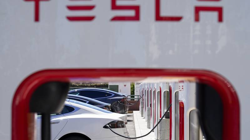FILE - Tesla vehicles charge at a station in Emeryville, Calif., Aug. 10, 2022. In a document...
