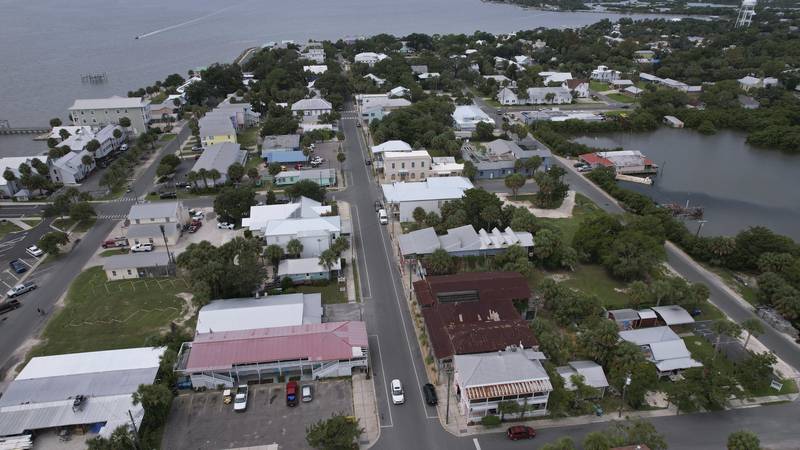 In this photo taken with a drone, businesses are seen along 2nd Street in Cedar Key, Fla.,...