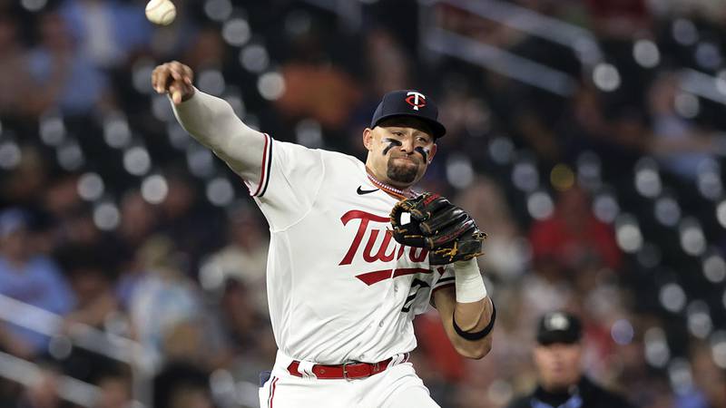 Minnesota Twins third baseman Royce Lewis throws out Texas Rangers' Marcus Semien at first...