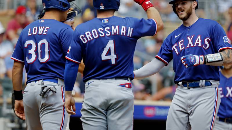 Texas Rangers' Jonah Heim, far right, celebrates his grand slam against the Minnesota Twins...