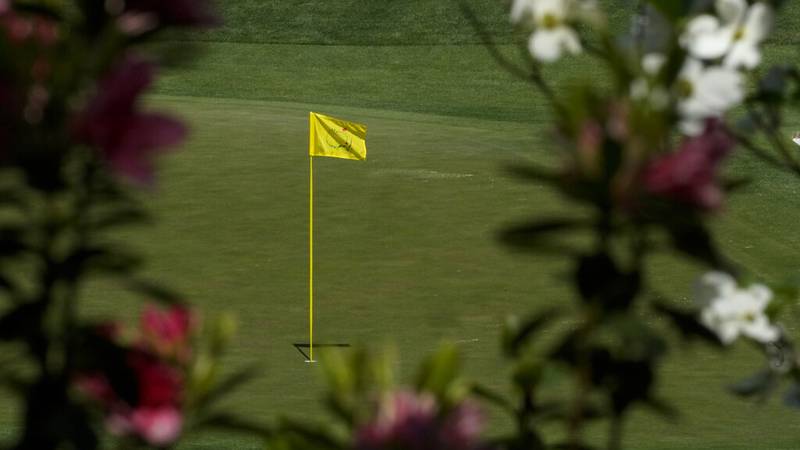 Azaleas frame the flag on the 16th Green during a practice round for the Masters golf...